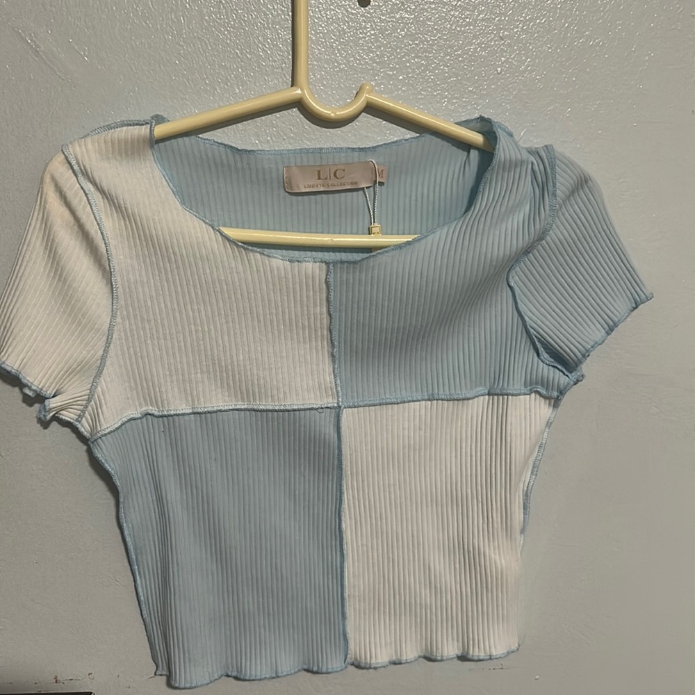A blue and white shirt , never worn